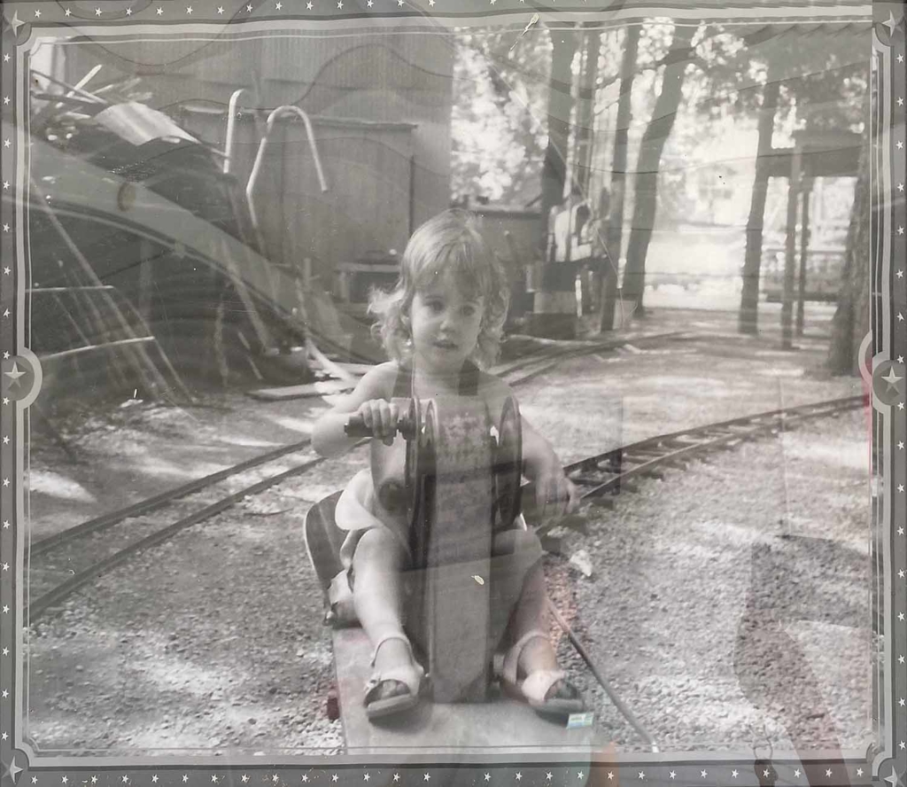 a vintage photo of a child on a roller coaster